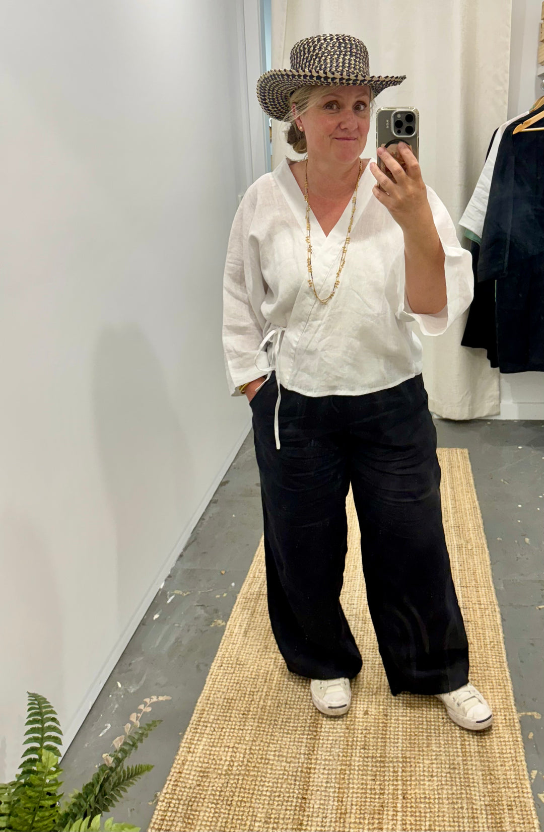 wide leg linen pant in black worn with white wrap linen shirt at jade and may