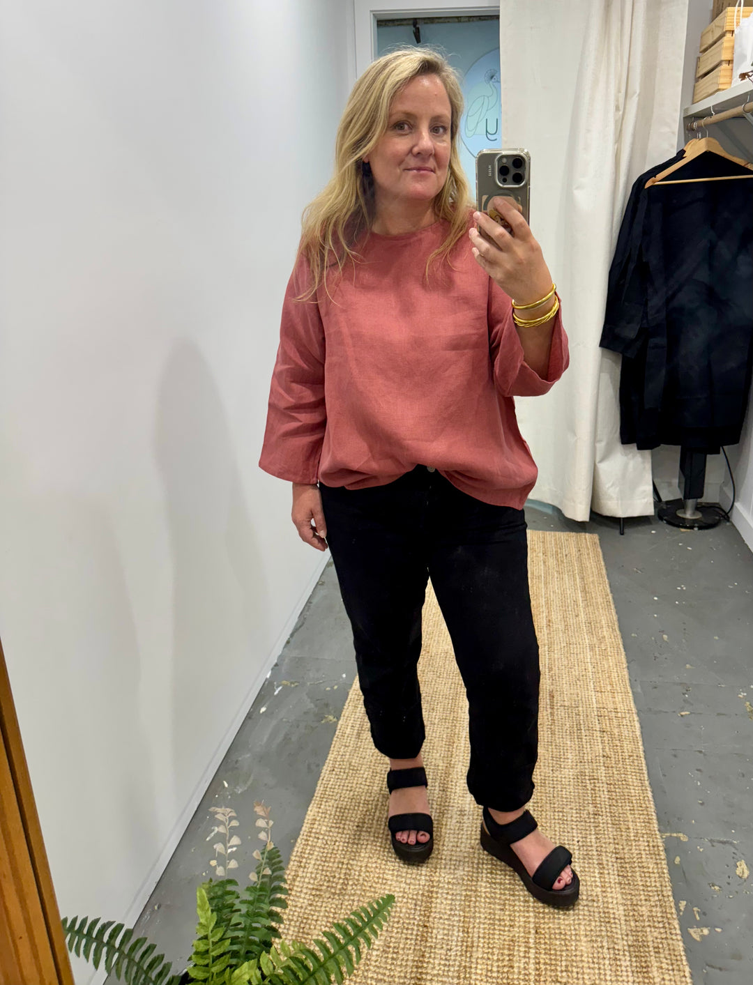 long sleeve linen top in antique red. lifestyle image shown with black jeans