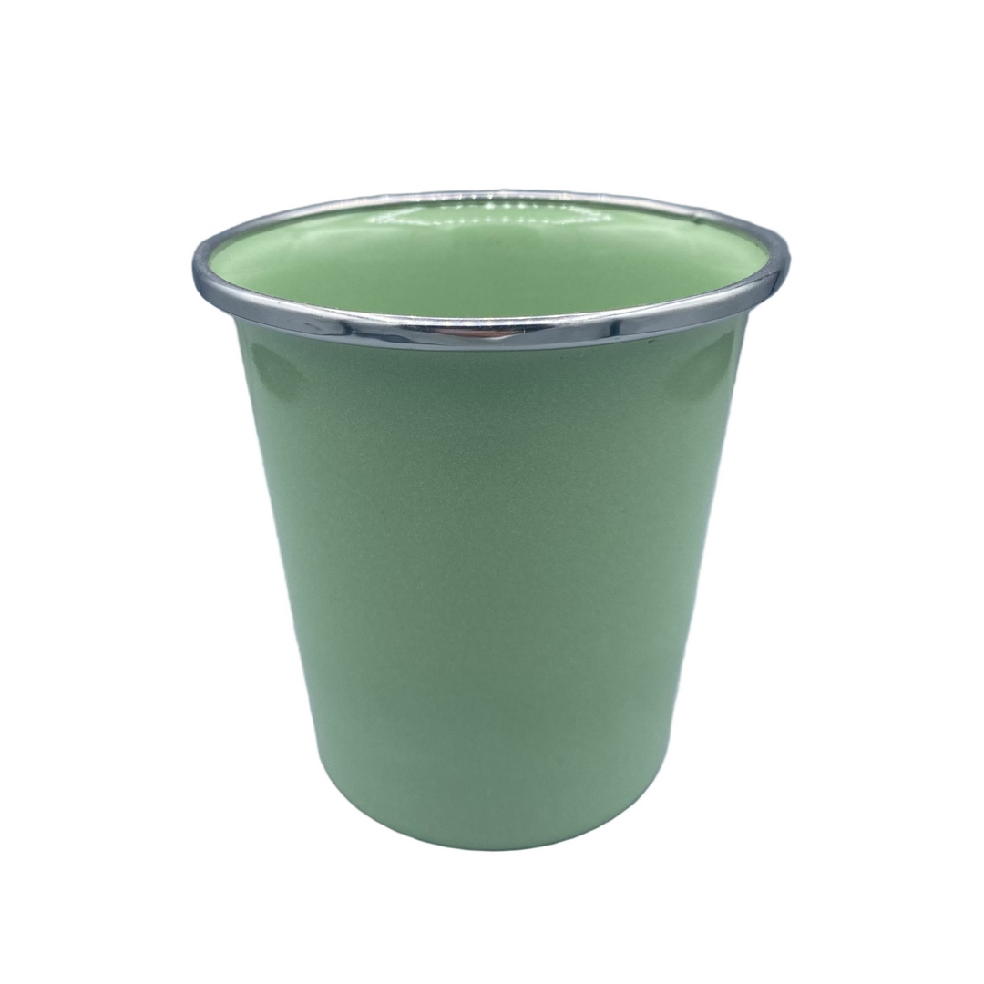 Green cup with silver rim on a gray background