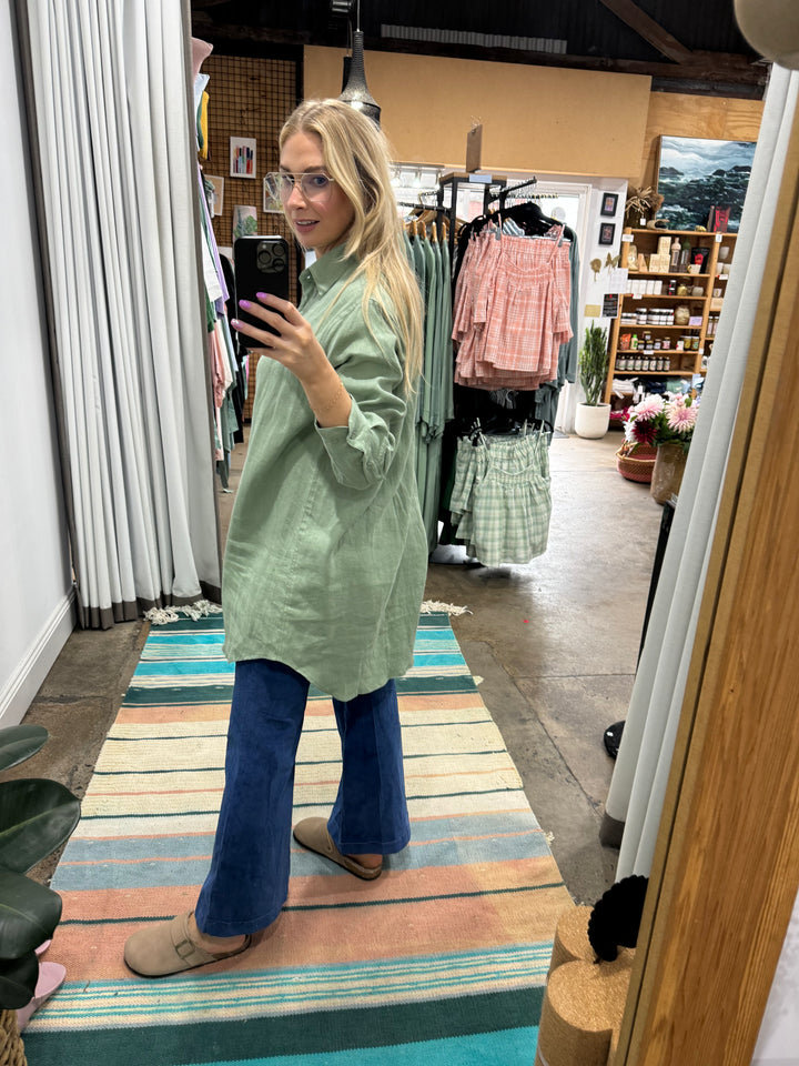 green linen shirt in long length worn with jeans at jade and may