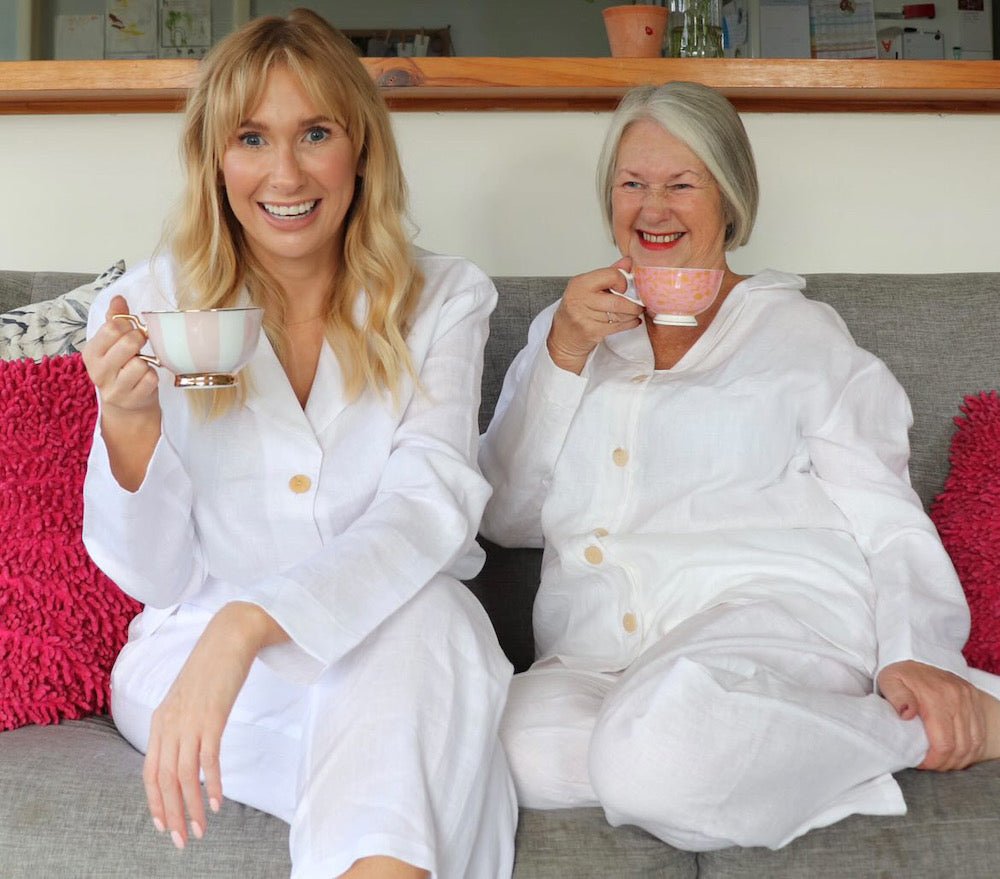 White Linen Pyjama Set - Classic Style - Pyjamas - mother and daughter wearing white linen pj set on couch with cup of tea