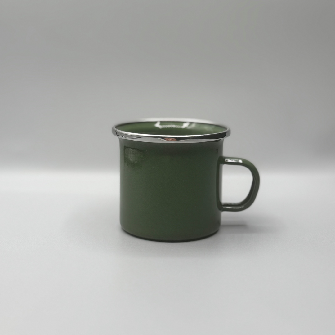 Green enamel mug on a white background