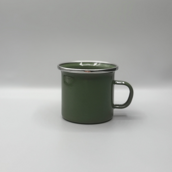 Green enamel mug on a white background