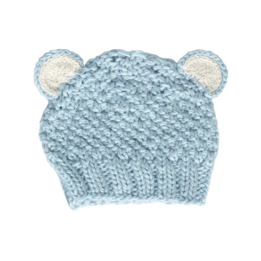 Knitted baby hat with bear ears on a white background