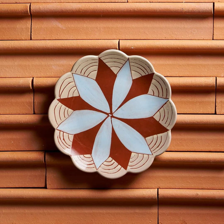 Decorative ceramic plate with geometric pattern on a wooden surface
