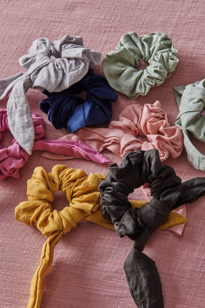 Linen Scrunchies in a bundle of different colours on a pink  blanket