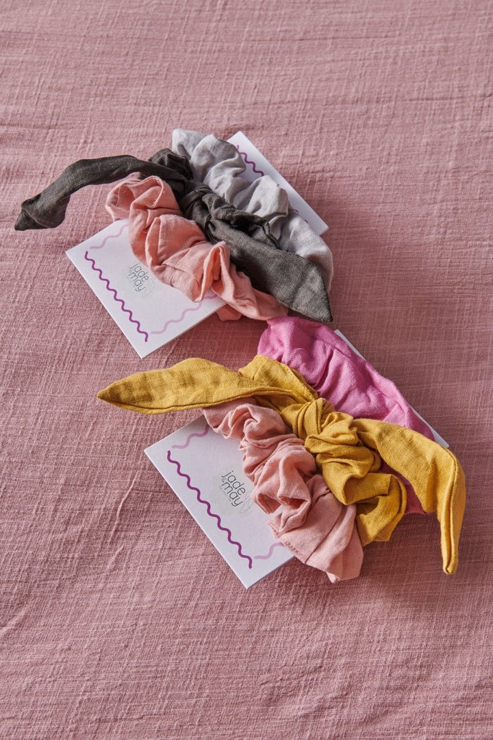 Linen Scrunchies. 3 packs of linen scrunchies sitting on a pink blanket